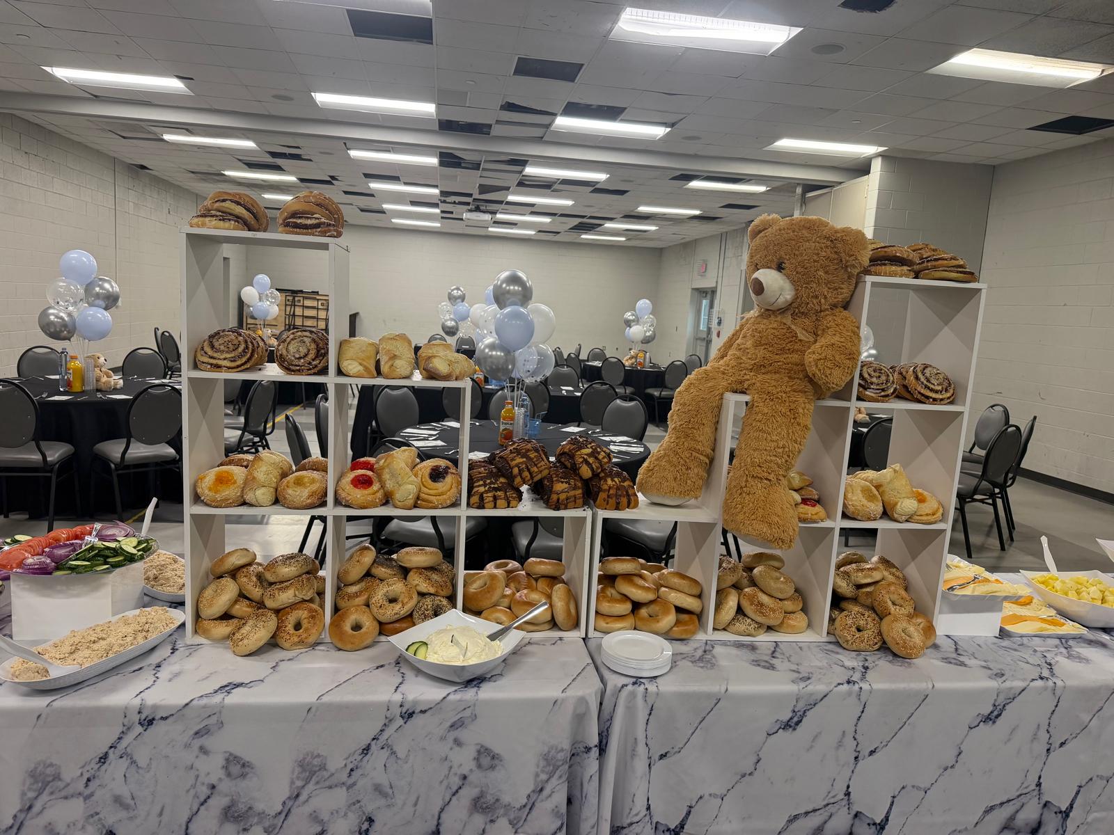 Bagel and pastry brunch display with teddy bear