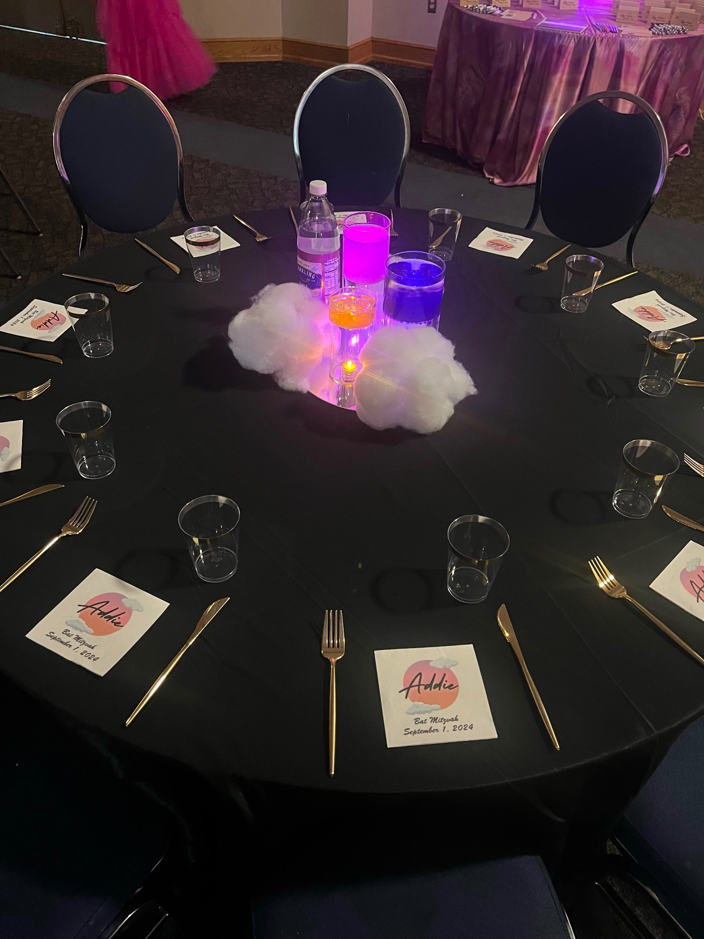 Addie's bat mitzvah table with cloud and sunset centerpiece